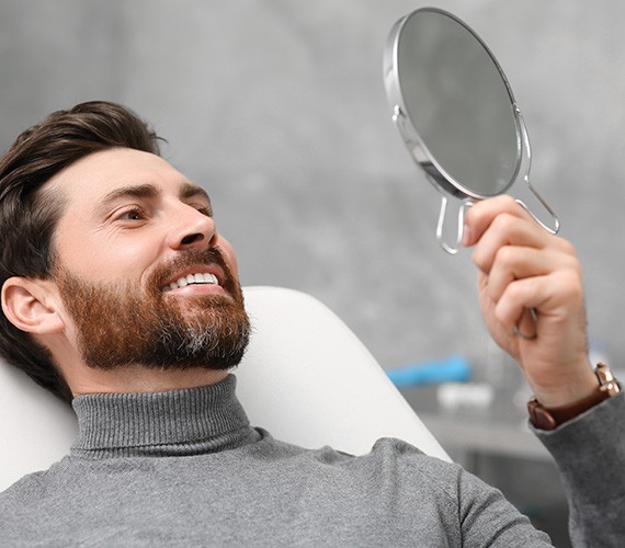 Fort Worth patient looking at bonding in mirror