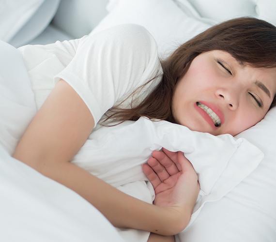 a person grinding their teeth while asleep