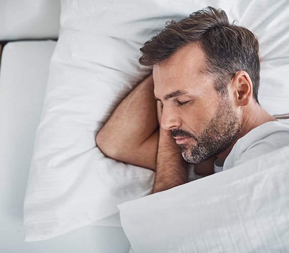 a man sleeping peacefully in bed