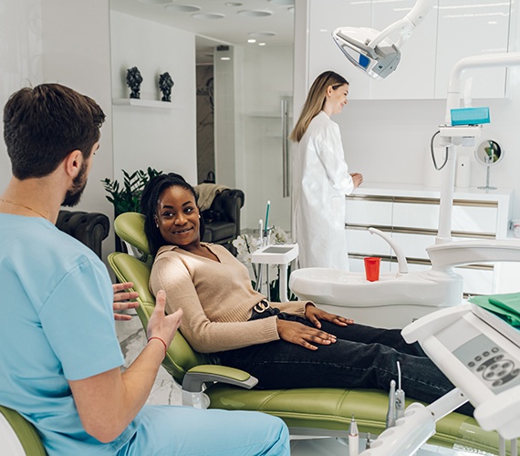 Patient in Fort Worth smiling while getting a dental checkup and cleaning