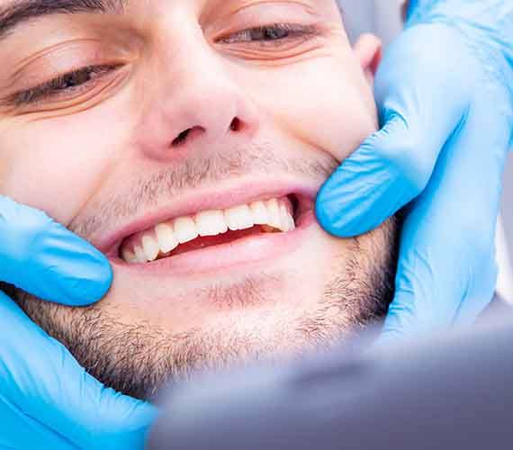 A dentist showing a patient’s smile to them
