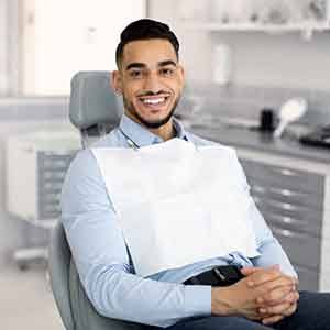 Man smiling while sitting in dentist's treatment chair