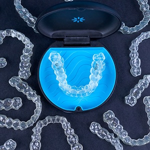 Bird’s eye view of Invisalign in case surrounded by multiple trays