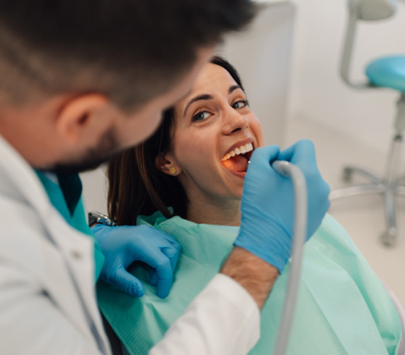 Gum recontouring uses a laser or scalpel to remove excess periodontal tissue